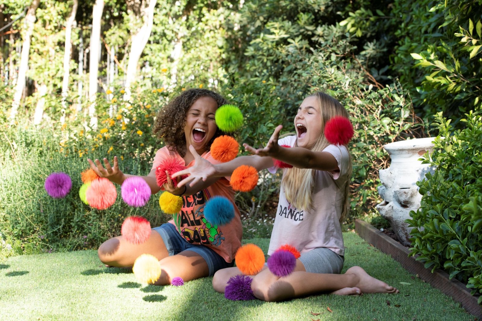 Friends tossing Koosh balls in a garden