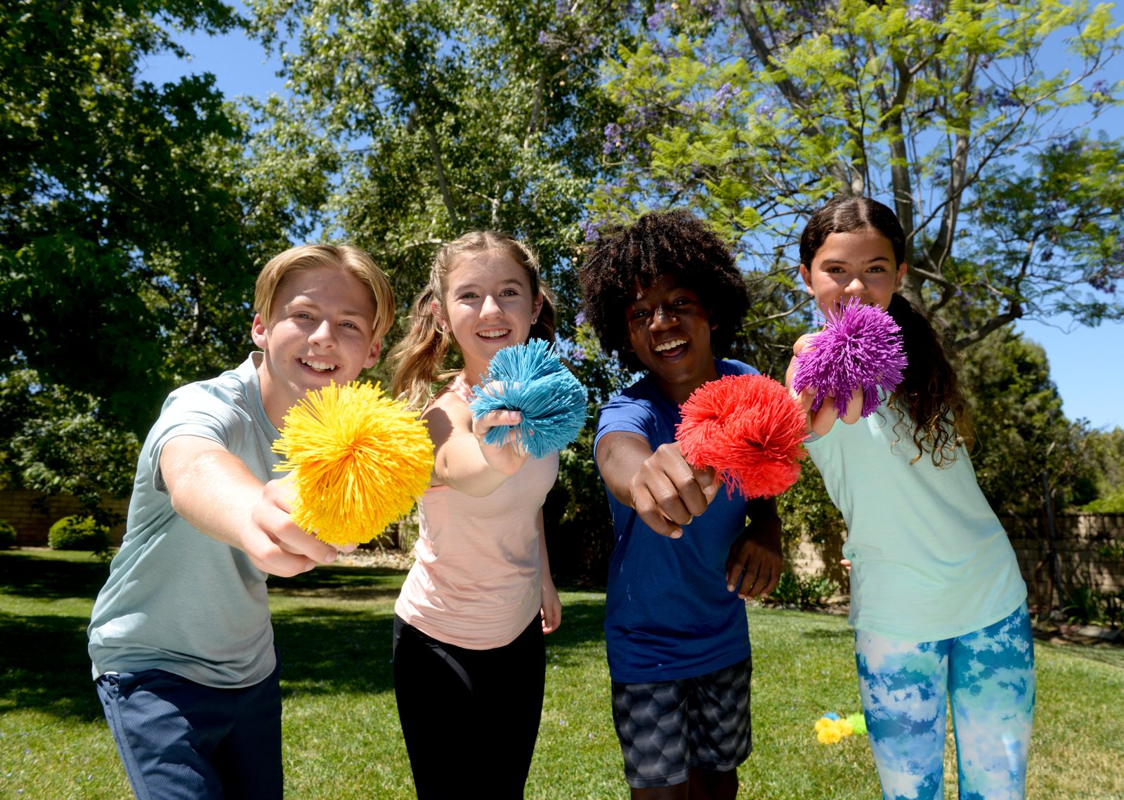 Kids holding Koosh balls outdoors